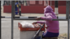 Sixteen-year-old girl Tribunal sells wares on a busy corner of Harare, Zimbabwe. Aug. 15, 2019. (C. Mavhunga/VOA) 