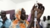 FILE - Staff members of a teaching hospital receive the first vaccination treatment for yellow fever in El Geneina, West Darfur, Nov. 14, 2012.
