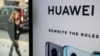 FILE - A pedestrian walks past a Huawei product stand at an EE telecommunications shop in central London, Britain, April 29, 2019.