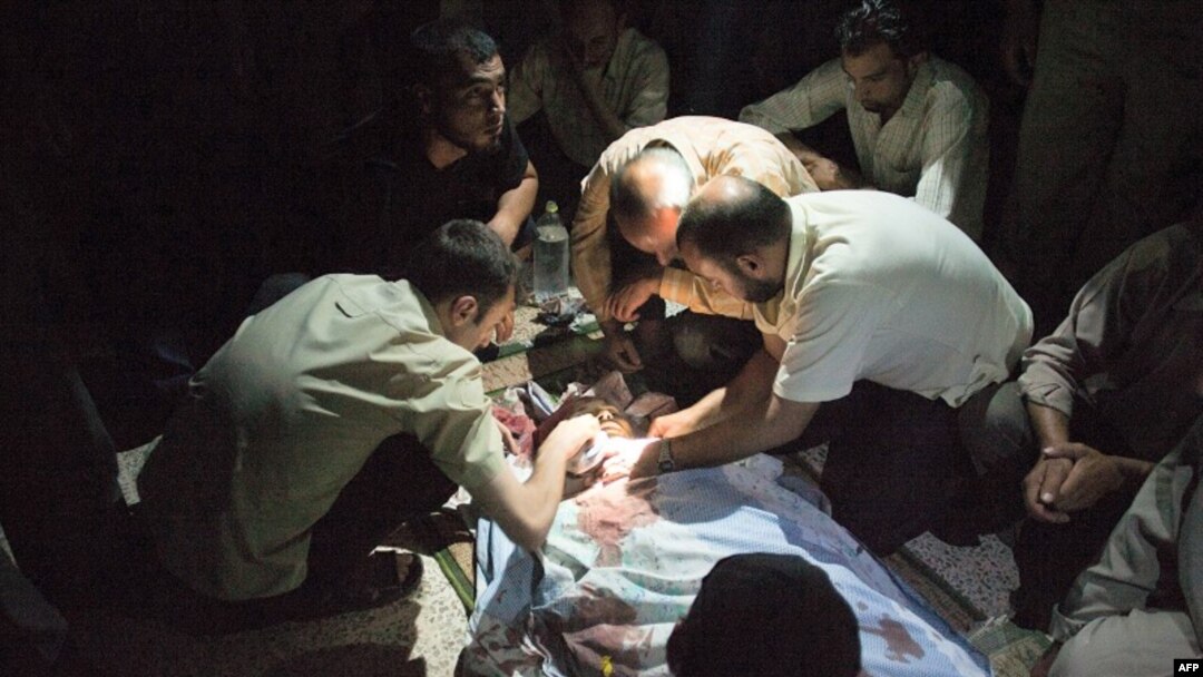 Syrians mourn over Mohammed Hafez, 30, who was killed by a gunshot to the head in Izaz, July 13, 2012