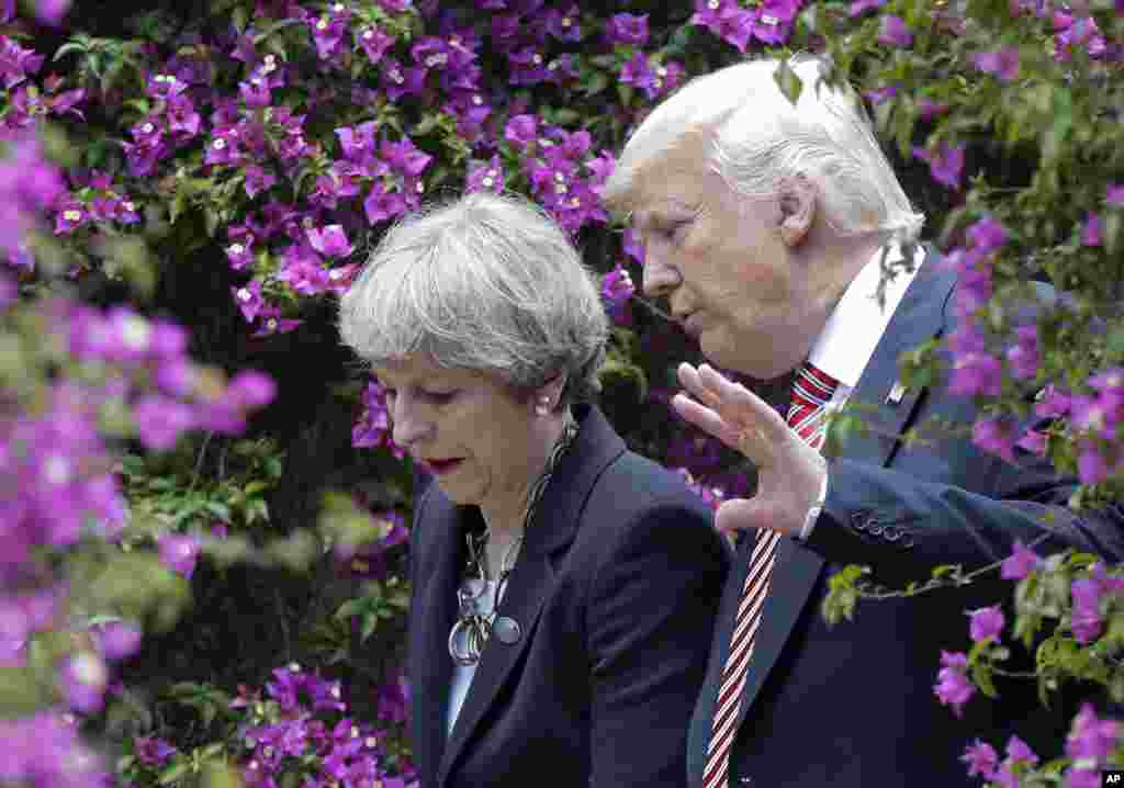 U.S. President Donald Trump talks with British Prime Minister Theresa May in Taormina, Italy.