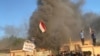 A headquarters building of Popular Mobilization Forces burns after being torched by demonstrators during ongoing anti-government protests, in Nassiriya, Iraq, Jan. 5, 2020.