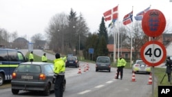 La policía danesa patrulla el cruce fronterizo con Alemania en Padborg, Dinamarca, el lunes, 4 de enero de 2016.
