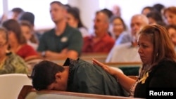 A graduating senior from Santa Fe High School reacts to Friday's school shooting during prayer services at the Arcadia First Baptist Church in Santa Fe, Texas, May 20, 2018.