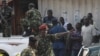 FILE - Burundi's former Defense Minister Cyrille Ndayirukiye, center, points during an attempted coup in the capital Bujumbura, May 13, 2015. 