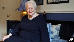 FILE - U.S. actress Olivia de Havilland poses during an interview, in Paris, June 18, 2016. The two-time Oscar-winning actress is suing FX Networks and producer Ryan Murphy's company, alleging unauthorized and false use of her name and invasion of privacy.