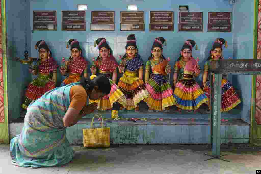 A villager prays in front of the idols of Hindu goddesses after special prayers for the victory of Democratic presidential nominee Vice President Kamala Harris, at Sri Dharmasastha temple in Thulasendrapuram, the ancestral village of Harris, in Tamil Nadu state, India.