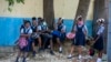 Student wait their turn to enter Lycee Marie Jeanne school on first day of school since the COVID-19 pandemic in Port-au-Prince, Haiti, Monday, Aug. 17, 2020. (AP Photo/Dieu Nalio Chery)