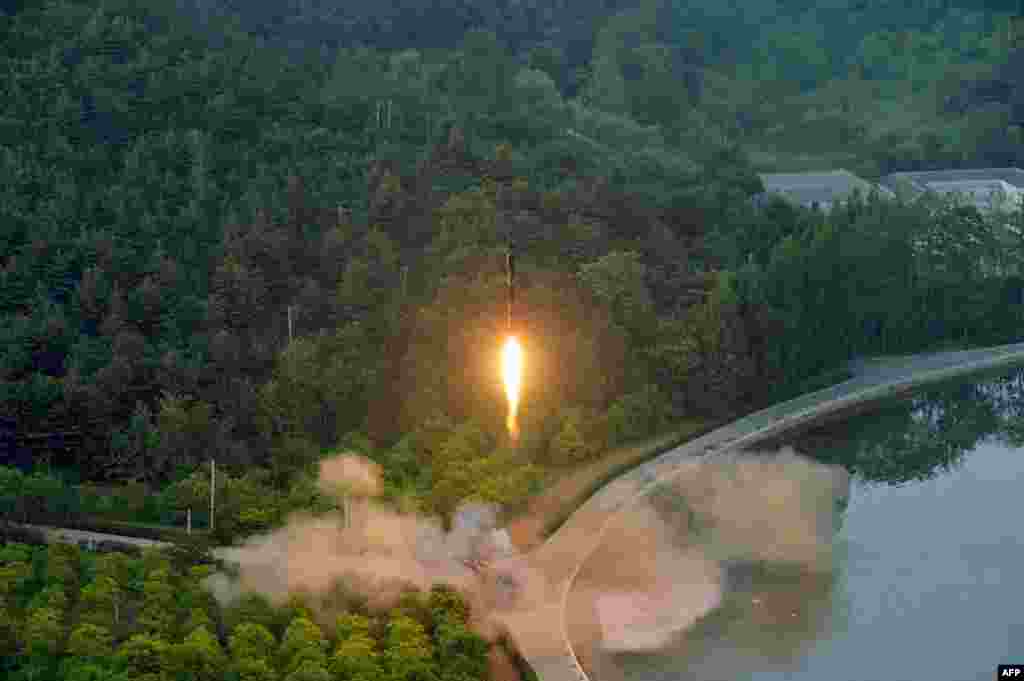 This undated photo released by North Korea's official Korean Central News Agency (KCNA) shows a test-fire of a ballistic missile at an undisclosed location in North Korea.