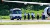 File Photo: Asylum seekers are pictured being transported from an aircraft to a bus upon their arrival on the island of Nauru, September 14, 2012. Australia has flooded Nauru with money since 2012, when the island became a key plank in its controversial policy of dealing with asylum seekers.