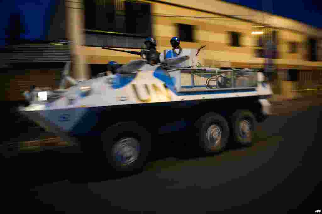 A United Nations armored personnel carrier patrols through the city of Goma following the sound of shell fire and gunshots, November 19, 2012.