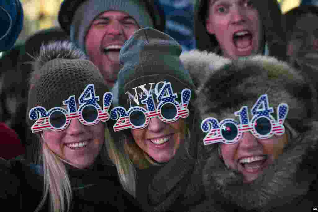 Revelers pose for a photograph as they wait for midnight during the New Year's Eve celebrations in Times Square in New York, Dec. 31, 2013.