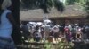 Chaos reigns outside Zimbabwe's registrar general's office in Harare as citizens wait to get various documents such as passports, birth certificates and identity documents, June 2019. (C. Mavhunga/VOA)