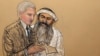 In this photo of a sketch by courtroom artist Janet Hamlin and reviewed by the U.S. Department of Defense, Khalid Sheikh Mohammed consults with his civilian attorney David Nevin during a break of his military hearing at the Guantanamo Bay U.S. Naval Base 