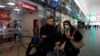 A woman wears a protective face mask at Roma Termini railway station, after the Italian government imposed a virtual lockdown on the north of the country, in Rome, March 8, 2020.