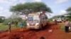 FILE - Kenyan security forces and others gather around the scene on an attack on a bus about 50 kilometers (31 miles) outside the town of Mandera, near the Somali border in northeastern Kenya Nov. 22, 2014.