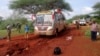 FILE - Kenyan security forces and others gather near the scene of a deadly bus attack 50 kilometers (31 miles) outside the town of Mandera, near the Somali border in northeastern Kenya, Nov. 22, 2014.