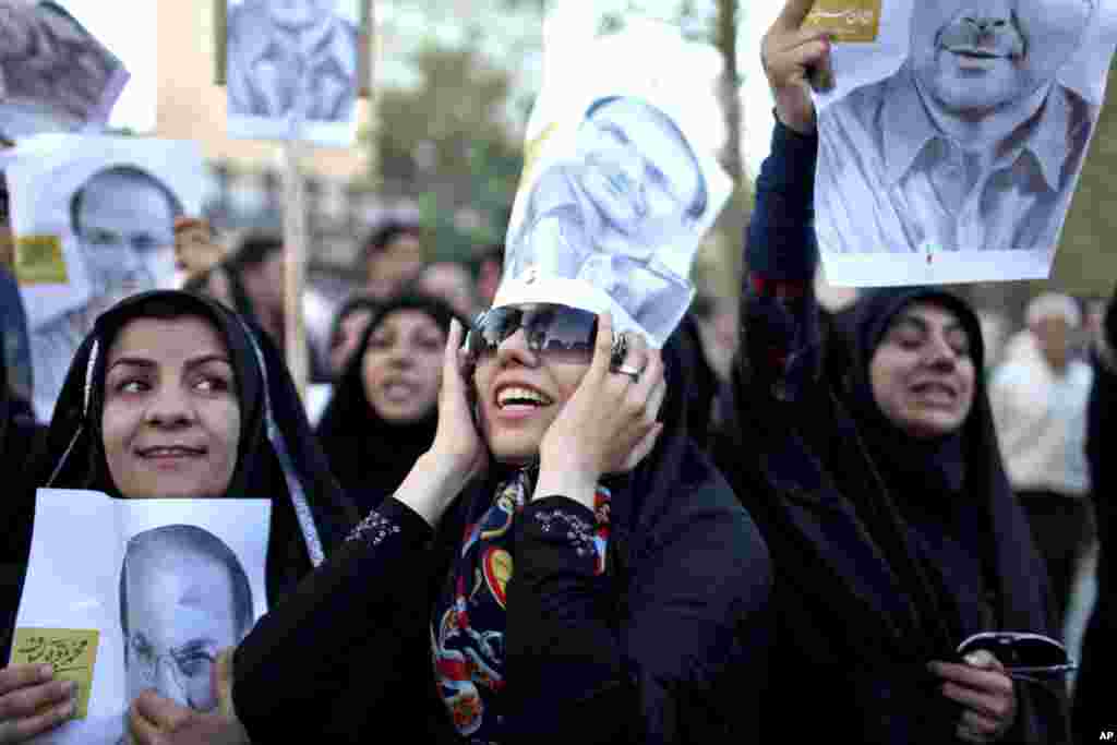 Supporters of Iranian presidential candidate Mohammad Bagher Qalibaf, who is also Tehran's mayor, chant during a street campaign, Tehran, Iran, June 9, 2013.
