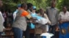 Elderly flood survivors receive assistance in the form of blankets, plastic mats, solar flashlights and other items, in Phalombe district, Malawi.