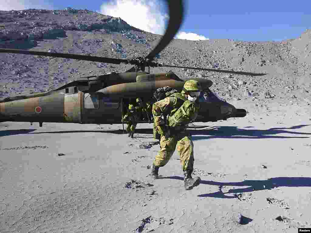 Japan Self-Defense Force (JSDF) soldiers run to assist in a rescue operation near the peak of Mt. Ontake, which straddles Nagano and Gifu prefectures, central Japan, Sept. 29, 2014.
