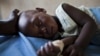A young girl with malaria rests in the inpatient ward of the Malualkon Primary Health Care Center in Malualkon, in the South Sudanese state of Northern Bahr el-Ghazal, June 1, 2012. 