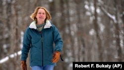 Judy Sandler was diagnosed with ADHD in her 50s. In this photo, she walks in the woods near her home in Lincolnville, Maine, January 23, 2025. (AP Photo/Robert F. Bukaty)