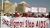 People holding banners march to campaign for increased aids awareness in the streets of Nigeria's capital Abuja December 1, 2006 on World Aids Day.