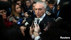 FILE - Brazil's President Michel Temer speaks to journalists at the Mercosur trade bloc summit in Mendoza, Argentina, July 21, 2017. 