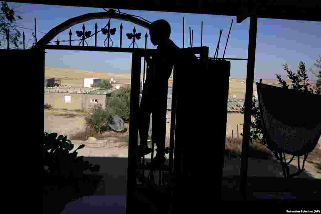In this Wednesday, July 31, 2013 photo, a Bedouin walks through the Negev desert near the village of al-Sira, Israel. 