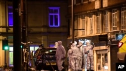 Police forensic officers work on the scene after a stabbing incident in Streatham neighborhood of London, England, Feb. 2, 2020. 