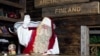 FILE - Santa Claus waves to his visitors as they leave his office in Santa Park near Rovaniemi, Finnish Lapland, on Dec. 14, 2011.