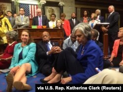 FILE - A photo shot and tweeted from the floor of the U.S. House of Representatives shows Democratic members of the House staging a sit-in on the House floor "to demand action on common sense gun legislation" on Capitol Hill, in Washington, June 22, 2016.