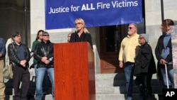 Consumer advocate Erin Brockovich, who famously took on Pacific Gas & Electric Co. in the 1990s, stands with wildfire victims and speaks outside the state Capitol in Sacramento, Calif., Jan. 22, 2019.