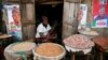 FILE - Latefat Alao, a ethnic Yoruba Muslim woman, waits for customers in Beere market in Ibadan, southwest Nigeria, Jan. 29, 2015.