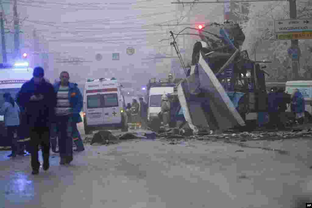 Ambulances line up at the site of a trolleybus explosion, background, in Volgograd, Russia. A bomb blast tore through the trolleybus, killing at least 10 people a day after a suicide bombing that killed at 17 at the city’s main railway station.