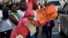 FILE - Doctors and other medical staff protest the detention of their union leaders, outside an appeals court in Nairobi, Kenya, Feb. 15, 2017. A court released seven doctors who were officials in the medics union; they had been jailed earlier in the week for not calling off a strike by doctors working in public institutions.