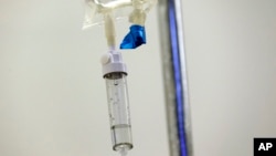 FILE - In this May 25, 2017 file photo, chemotherapy drugs are administered to a patient at a hospital in Chapel Hill, N.C. (AP Photo/Gerry Broome, File)