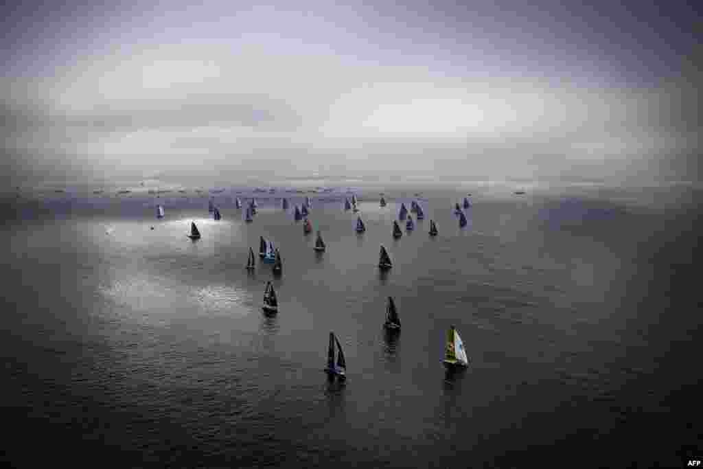 Skippers sail their Imoca 60 monohulls at the start the 10th edition of the Vendee Globe around the world monohull solo sailing race, off Les Sables-d'Olonne, France.