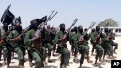 FILE - Hundreds of newly trained al-Shabab fighters perform military exercises near Mogadishu, Somalia. 