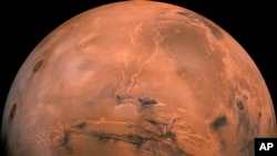This image made available by NASA shows the planet Mars. It was created from over 100 images taken by Viking Orbiters in the 1970s. (NASA via AP)