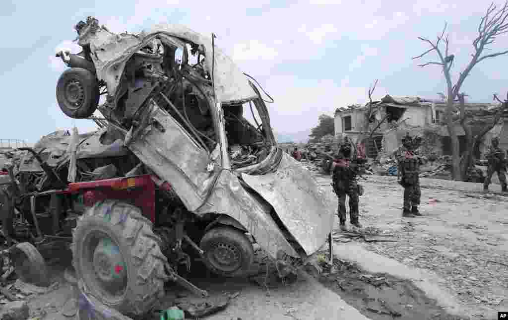 Afghanistan's security forces patrol the site of a suicide attack in the Urgun town of Paktika province.
