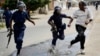 Riot police chase a demonstrator in Bujumbura, Burundi, May 4, 2015.