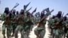 FILE - Al-Shabab fighters are seen marching with their weapons during exercises on the outskirts of Mogadishu, Somalia, Feb. 17, 2011. The Pentagon says President Donald Trump has given it more authority to attack al-Shabab targets