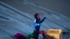 Un niño migrante llora para tratar de llamar la atención de su padre mientras su familia aguarda en la orilla sur de Río Grande para cruzar a El Paso, Texas, desde Ciudad Juárez, México, el miércoles 21 de diciembre de 2022 (Foto AP/Andres Leighton)