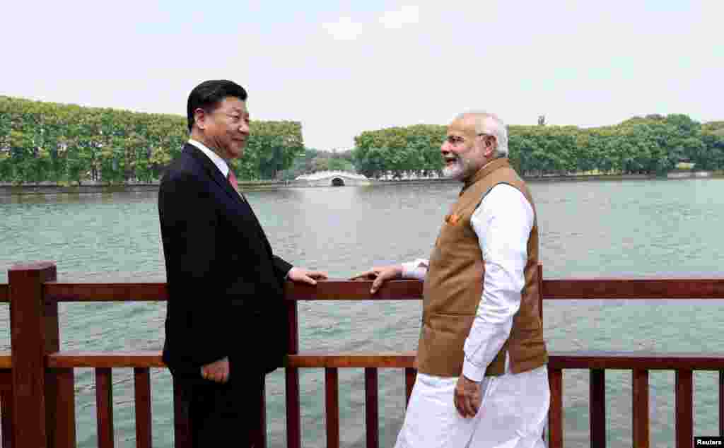 2018年4月28日,中国国家主席习近平和印度总理纳伦德拉·莫迪在中国武汉沿东湖漫步时交谈(印度新闻局通过路透社发布的照片)。两人举行了为期两天的非正式会晤。他们同意在两国有争议的边界上维持和平。中国外交部副部长孔铉佑称,这是中印关系中一次里程碑式的会晤。