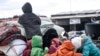 Civilians flee from Idlib toward the north to find safety inside Syria near the border with Turkey, Feb. 15, 2020. Syrian troops are waging an offensive in the last rebel stronghold.
