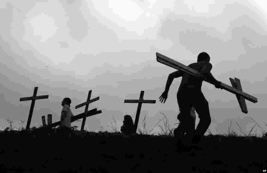 Demonstrators place crosses, representing people who died during the most recent protest, during a national sit-in against President Nicolas Maduro, in Caracas, Venezuela.