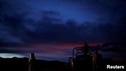 Soldiers assigned to the National Guard keep watch while escorting a caravan of vehicles with relatives and friends arriving for the funerals of slain members of the Mexican-American Mormon families, in Bavispe, Sonora state, Mexico November 6, 2019.