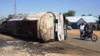 A motorcycle rides past what remains of a fuel tanker whose explosion killed more than 140 people in Majiya, Nigeria, on Oct. 16, 2024.