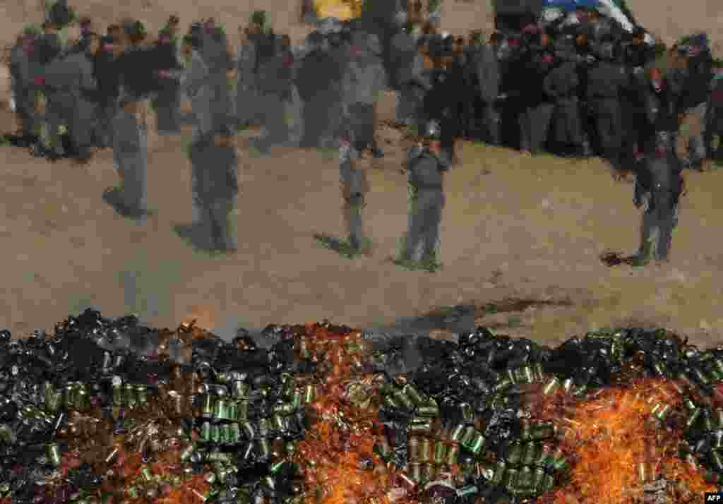 Pejabat pemerintah Afghanistan dan polisi menyaksikan pembakaran kaleng-kaleng berisi alkohol dan narkoba yang berhasil disita di Kabul.